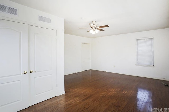 unfurnished room with ceiling fan and dark hardwood / wood-style flooring