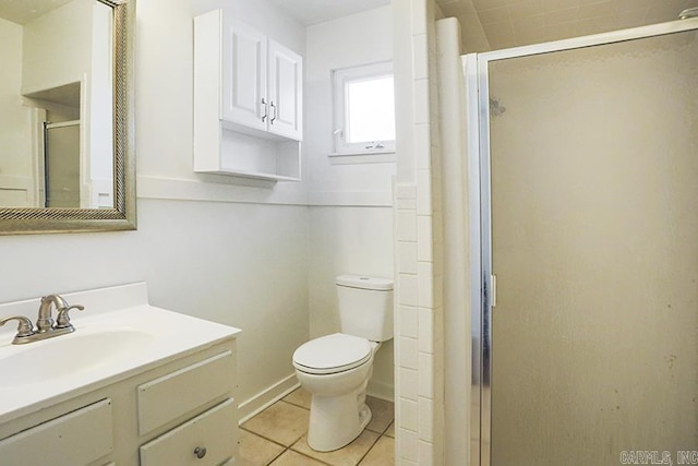 bathroom with vanity, toilet, tile patterned floors, and walk in shower