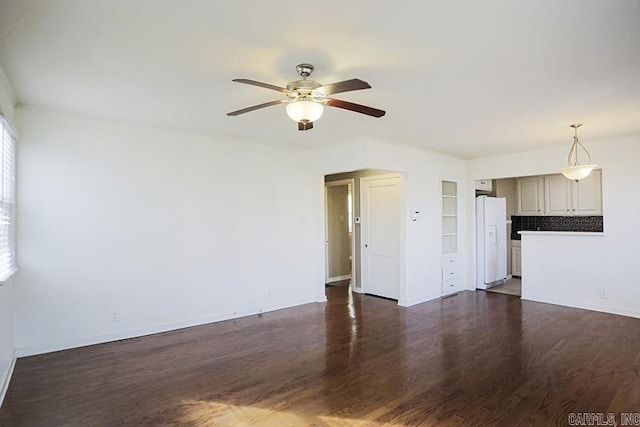 unfurnished living room with dark hardwood / wood-style floors and ceiling fan