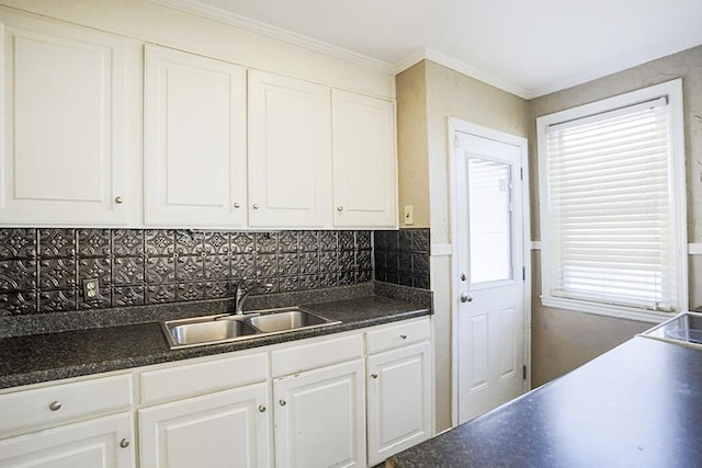 kitchen featuring white cabinetry, sink, decorative backsplash, and a wealth of natural light