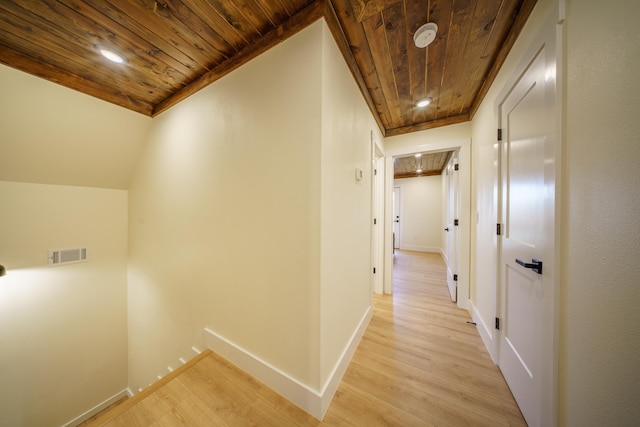 hallway featuring wood ceiling, vaulted ceiling, and light wood-type flooring