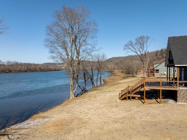 exterior space featuring a deck with water view