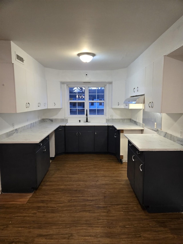 kitchen with dark hardwood / wood-style floors, sink, and white cabinets