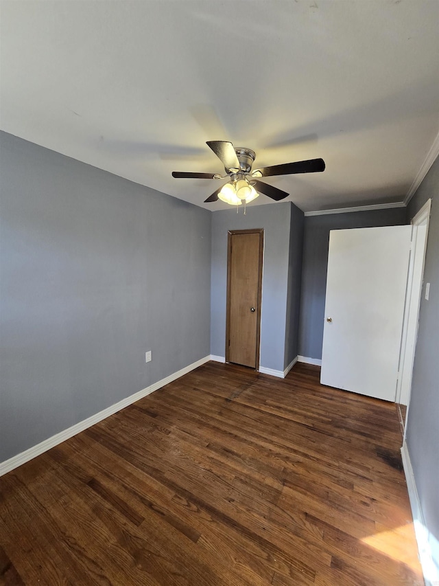 unfurnished bedroom with dark wood-type flooring and ceiling fan