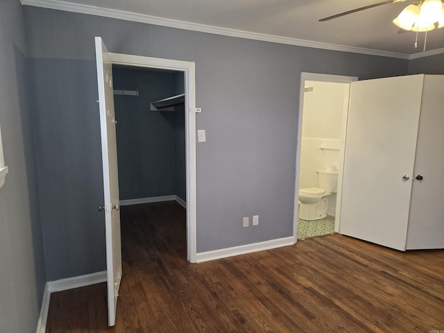 unfurnished bedroom with dark hardwood / wood-style flooring, a walk in closet, and a closet