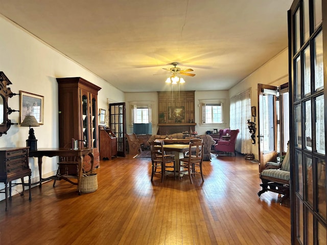 dining space with hardwood / wood-style flooring and ceiling fan