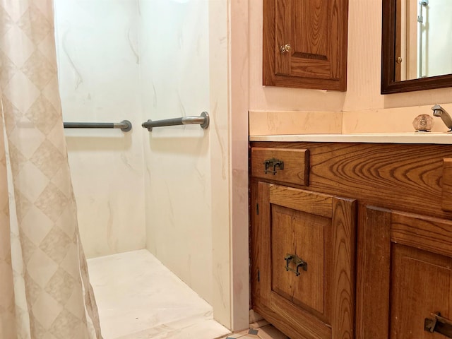 bathroom with walk in shower and vanity