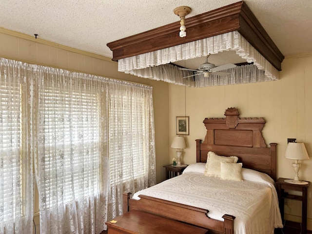 bedroom with ornamental molding and a textured ceiling