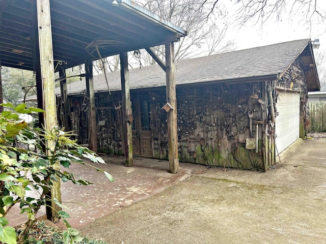 view of patio featuring a garage and an outbuilding