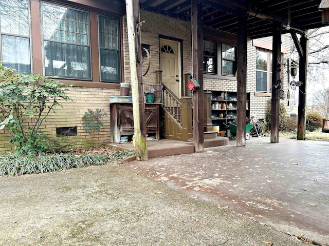 view of exterior entry with a patio