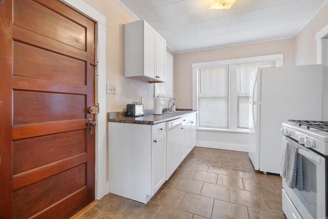 kitchen with white cabinetry, white appliances, crown molding, and sink