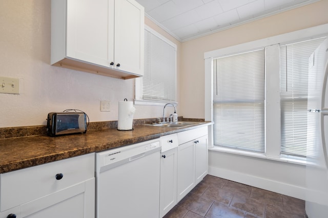 kitchen featuring sink, dark stone countertops, white cabinets, white dishwasher, and crown molding