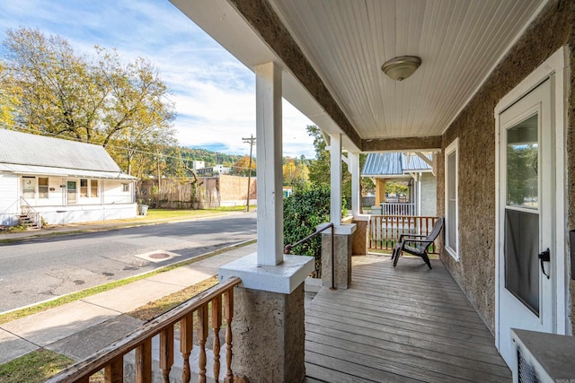 wooden terrace with a porch