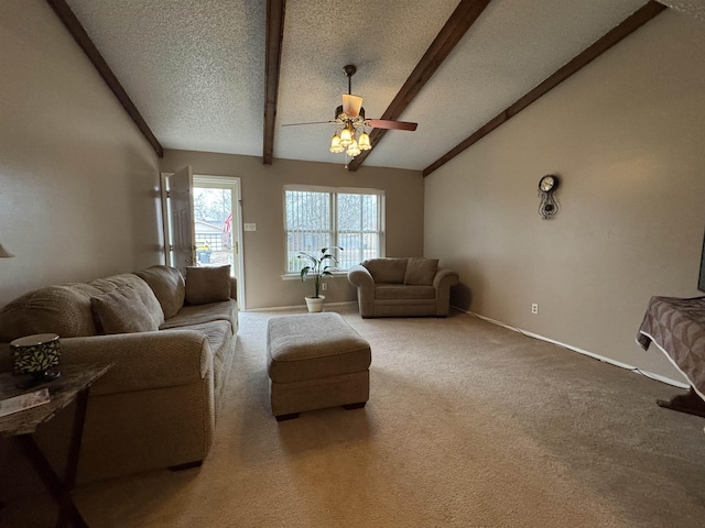 living room featuring lofted ceiling with beams, ceiling fan, carpet floors, and a textured ceiling