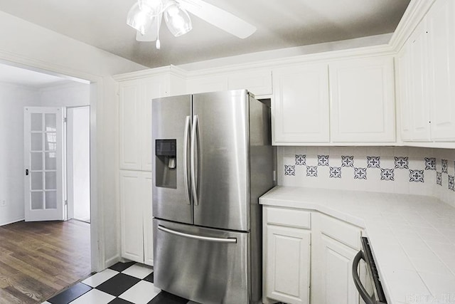 kitchen with white cabinetry, stainless steel refrigerator with ice dispenser, tile countertops, and ceiling fan