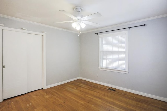 unfurnished bedroom with wood-type flooring, ornamental molding, and ceiling fan