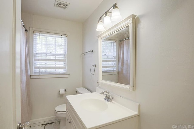 bathroom with vanity, tile patterned flooring, and toilet