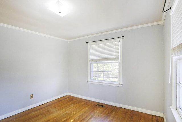 spare room with wood-type flooring and crown molding