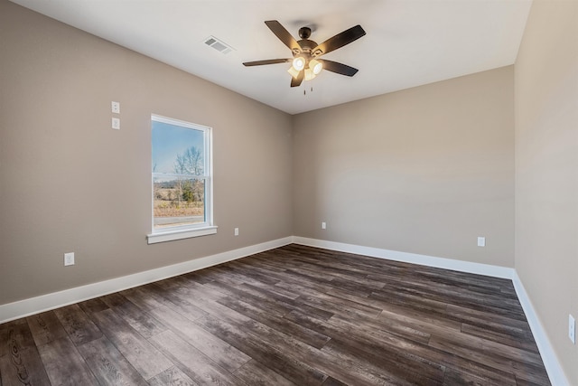 empty room with dark hardwood / wood-style flooring and ceiling fan