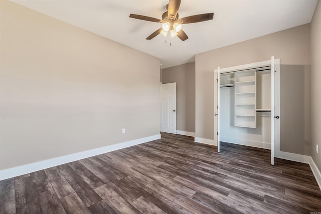 unfurnished bedroom with dark wood-type flooring, ceiling fan, and a closet