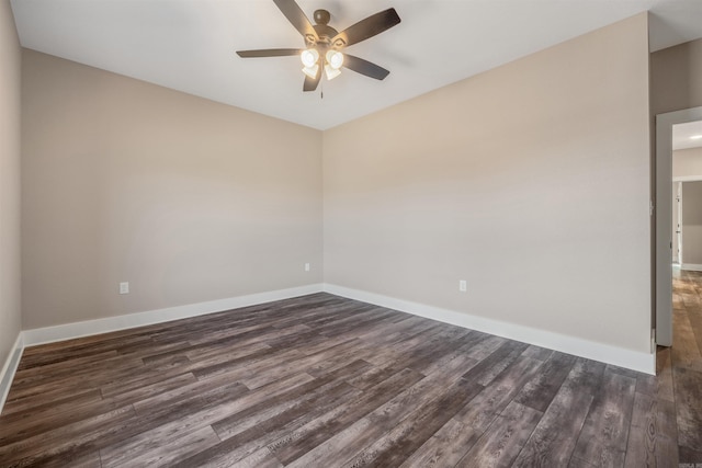 spare room with ceiling fan and dark hardwood / wood-style floors