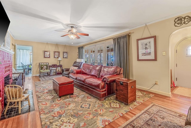 living room featuring french doors, ceiling fan, ornamental molding, and hardwood / wood-style floors