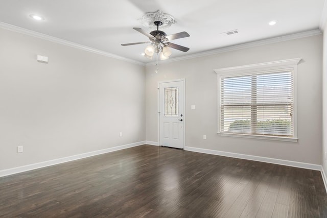 empty room featuring crown molding, dark hardwood / wood-style floors, and ceiling fan