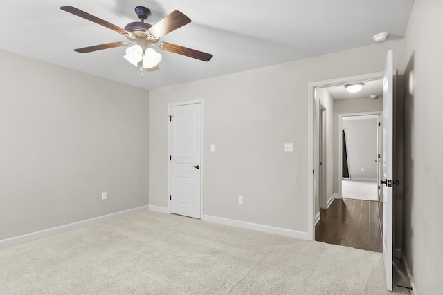 unfurnished bedroom featuring ceiling fan and carpet