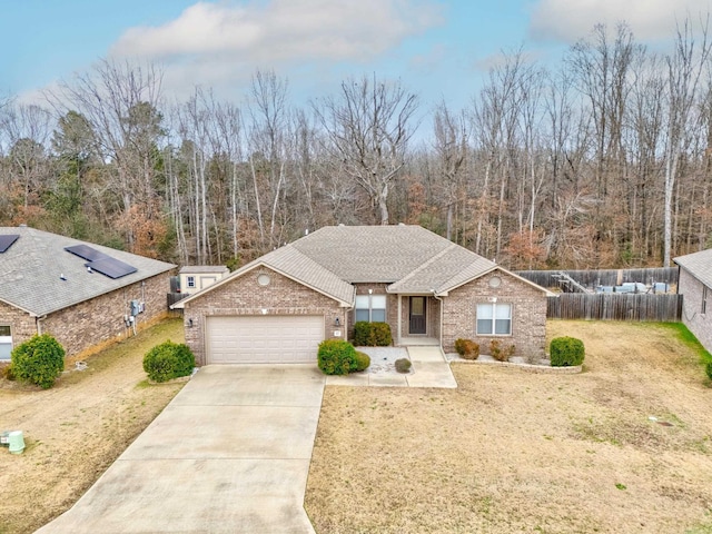 view of front of house featuring a garage and a front lawn