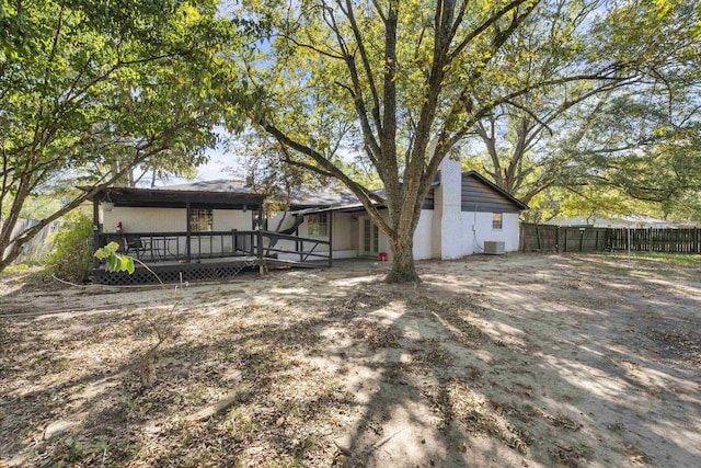 rear view of property featuring a wooden deck