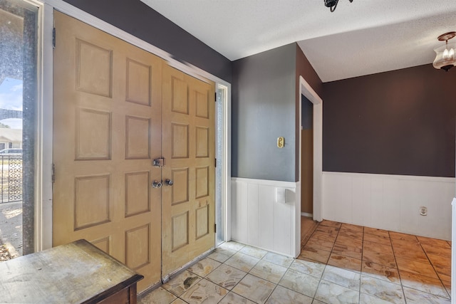 entrance foyer with a textured ceiling