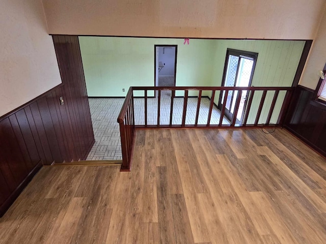 stairs with wood-type flooring and wooden walls