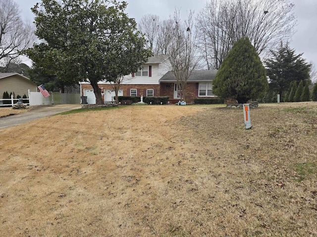 view of front of house with a garage and a front lawn