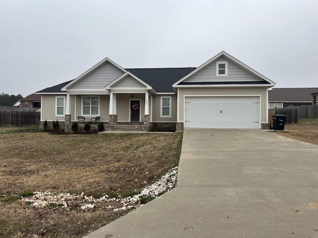 craftsman-style house featuring a garage and a front lawn