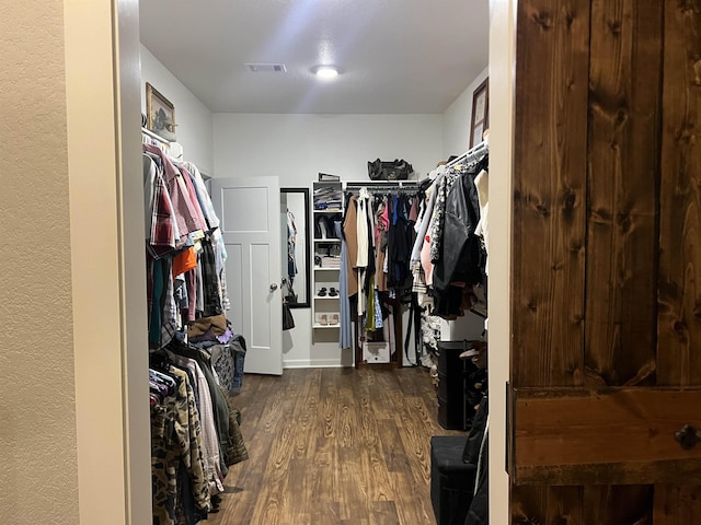 spacious closet with dark wood-type flooring