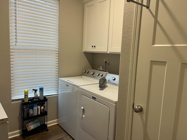 laundry room featuring dark hardwood / wood-style flooring, cabinets, and washing machine and clothes dryer