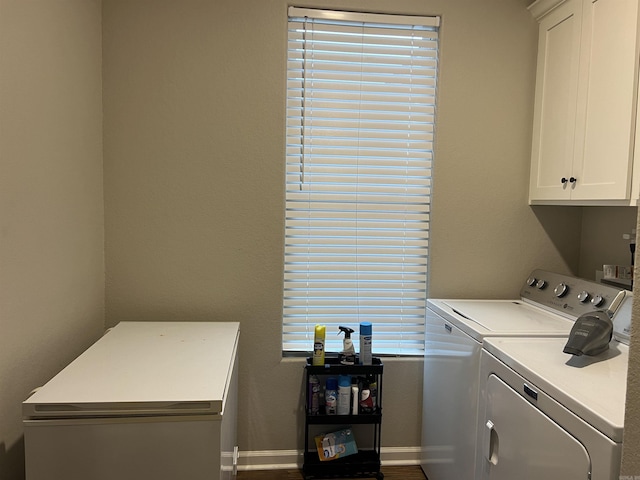 laundry area with cabinets and washing machine and dryer