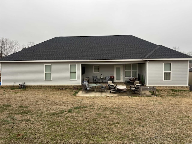 back of property with a lawn and a patio area