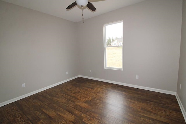 unfurnished room with dark wood-type flooring and ceiling fan