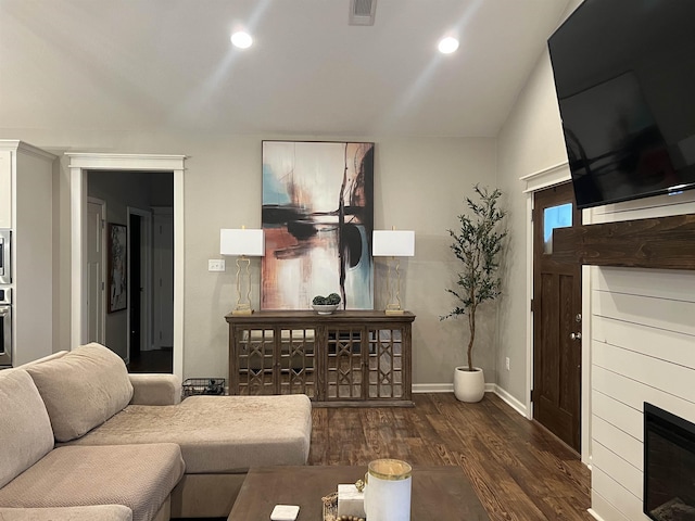 living room with lofted ceiling and dark wood-type flooring