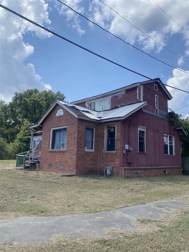 view of side of property with a yard