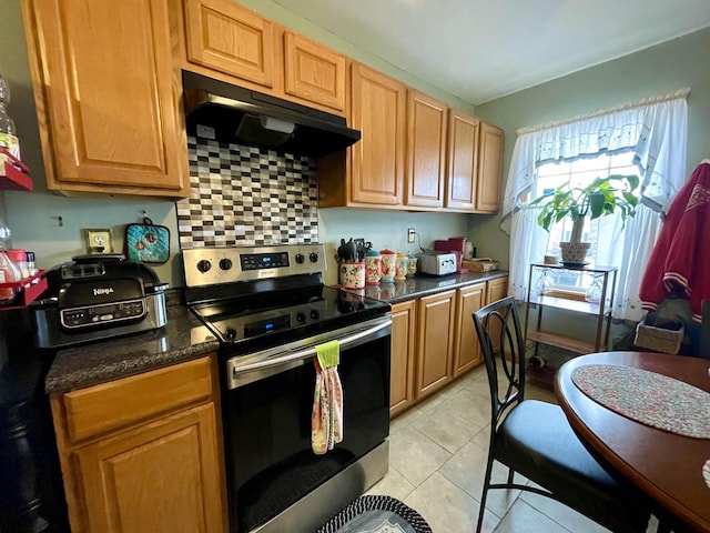 kitchen featuring tasteful backsplash, light tile patterned floors, and stainless steel electric range oven