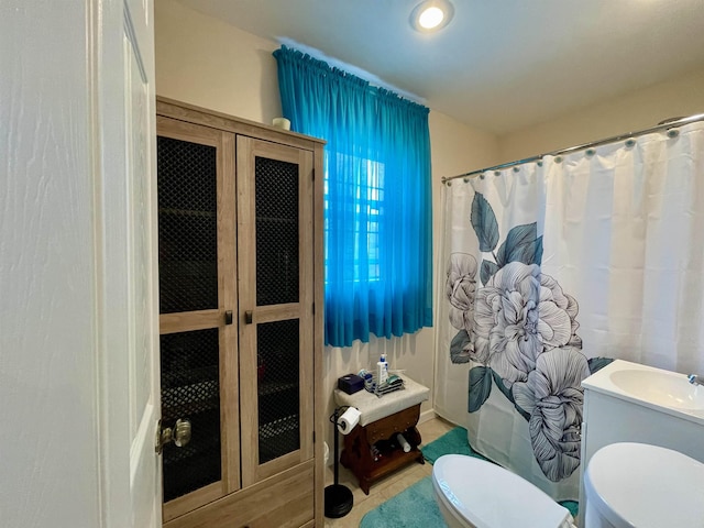 bathroom featuring walk in shower and toilet