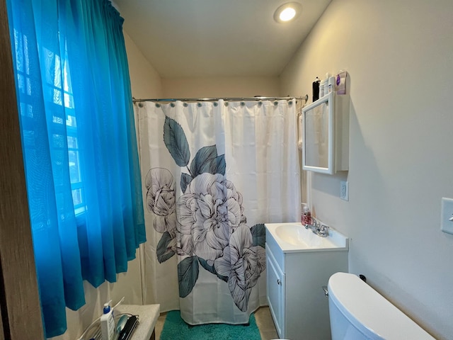 bathroom with vanity, toilet, and a shower with curtain