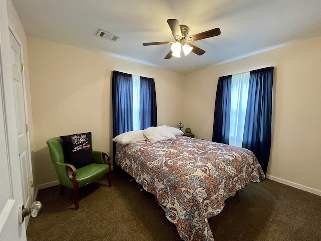 bedroom featuring ceiling fan and dark carpet