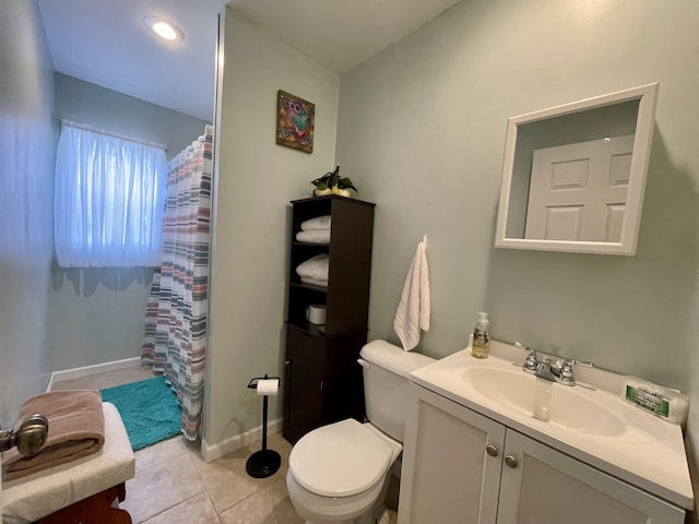 bathroom with vanity, toilet, and tile patterned flooring