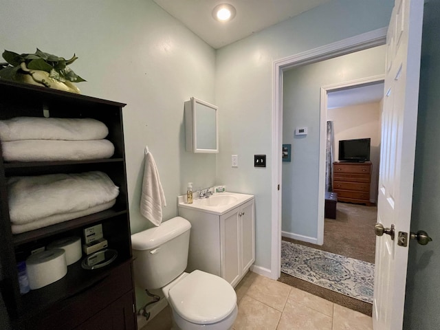 bathroom with tile patterned floors, vanity, and toilet