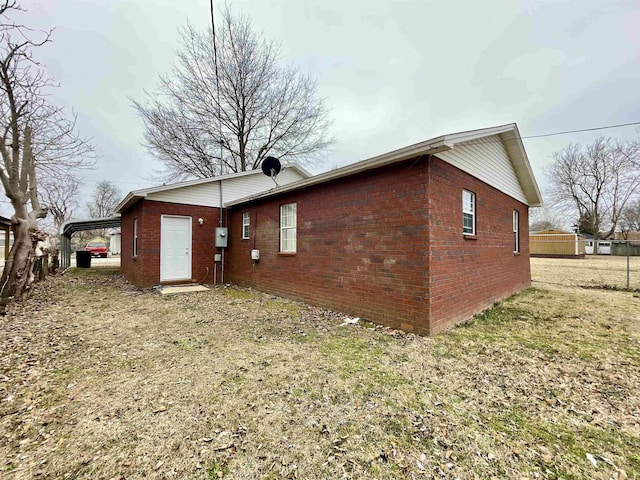 view of property exterior featuring a lawn and a carport