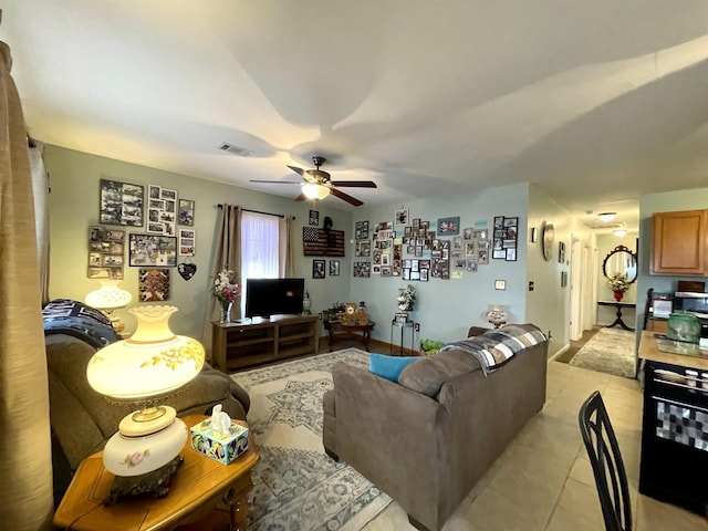 living room featuring light tile patterned floors and ceiling fan