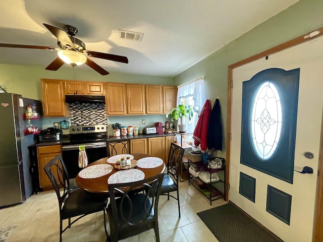 kitchen with backsplash, light tile patterned floors, stainless steel appliances, and ceiling fan